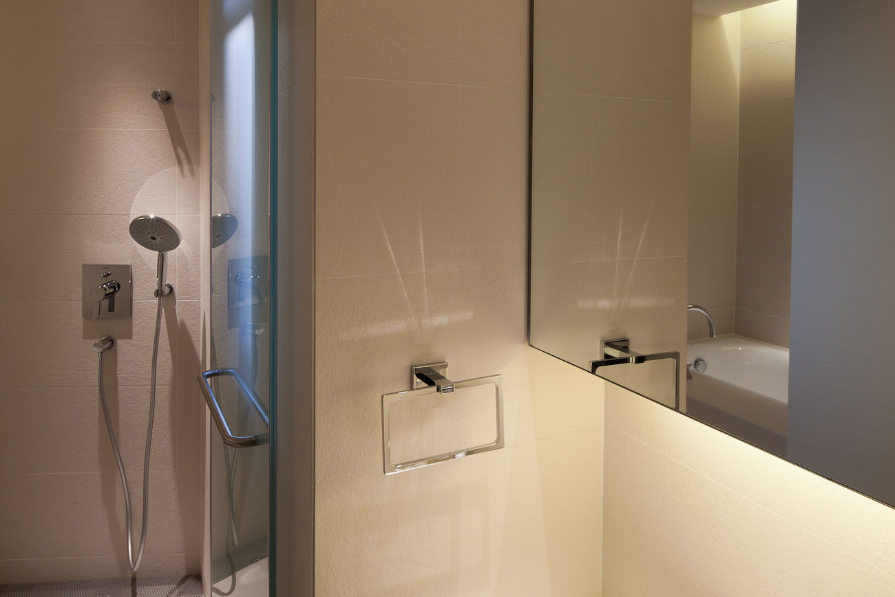 lui design associates designer interior apartment condo residential earth tones wood minimal hong kong china architecture brick stone shower bathroom mirror faucet chrome